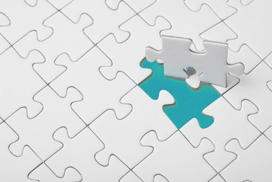A colour image of a puzzle being completed as a metaphor for the service integration of Oakford Group