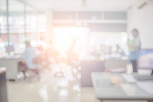People working at a desk as a metaphor for Oakford Group conducting market analysis