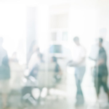 A colour picture of people interacting in a business setting symbolising working with Oakford Group